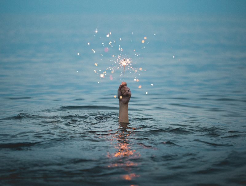 magic sparkler held above water